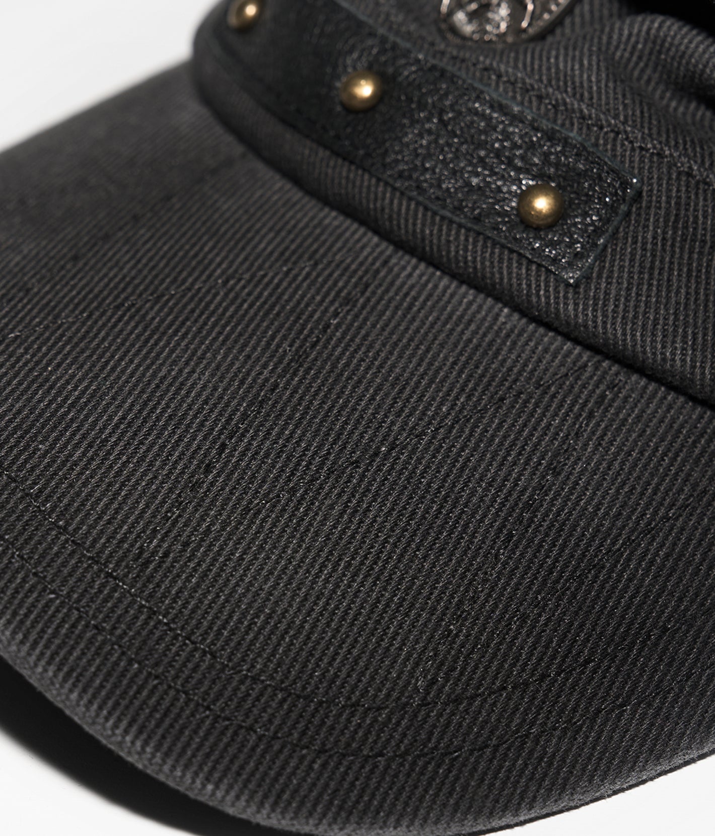 Black cap with gold buttons on a white background