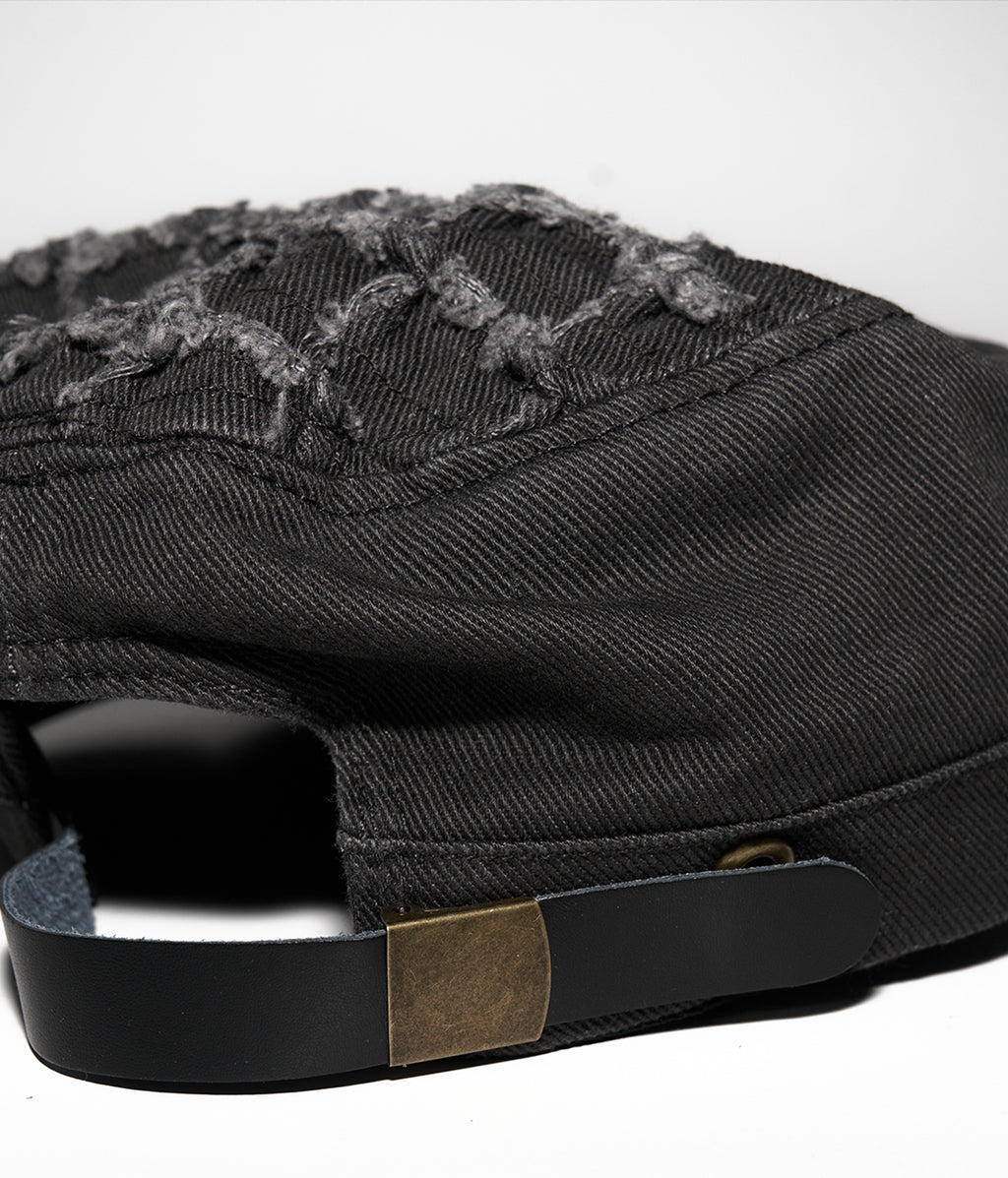 Black cap with embroidered design on a white background