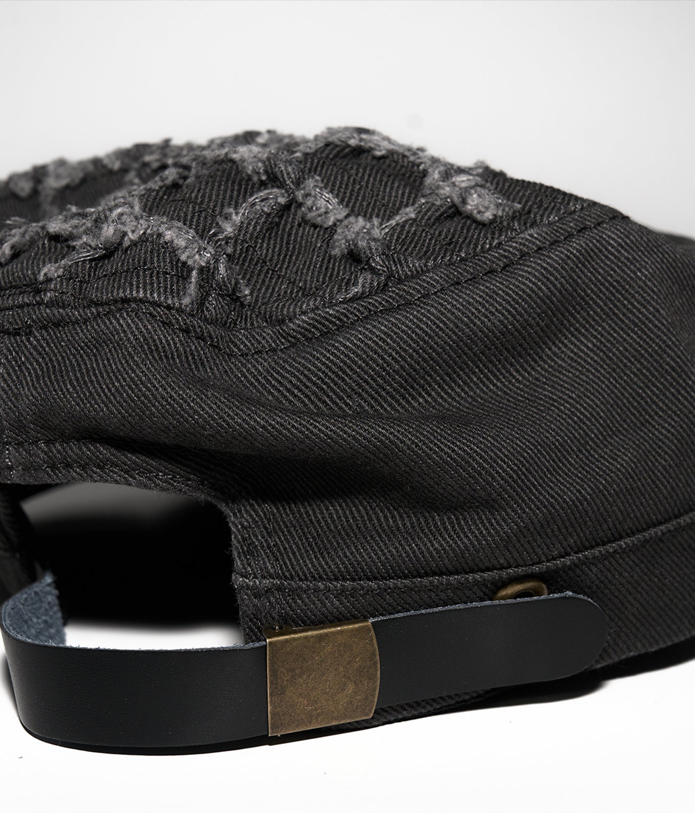 Black cap with embroidered design on a white background