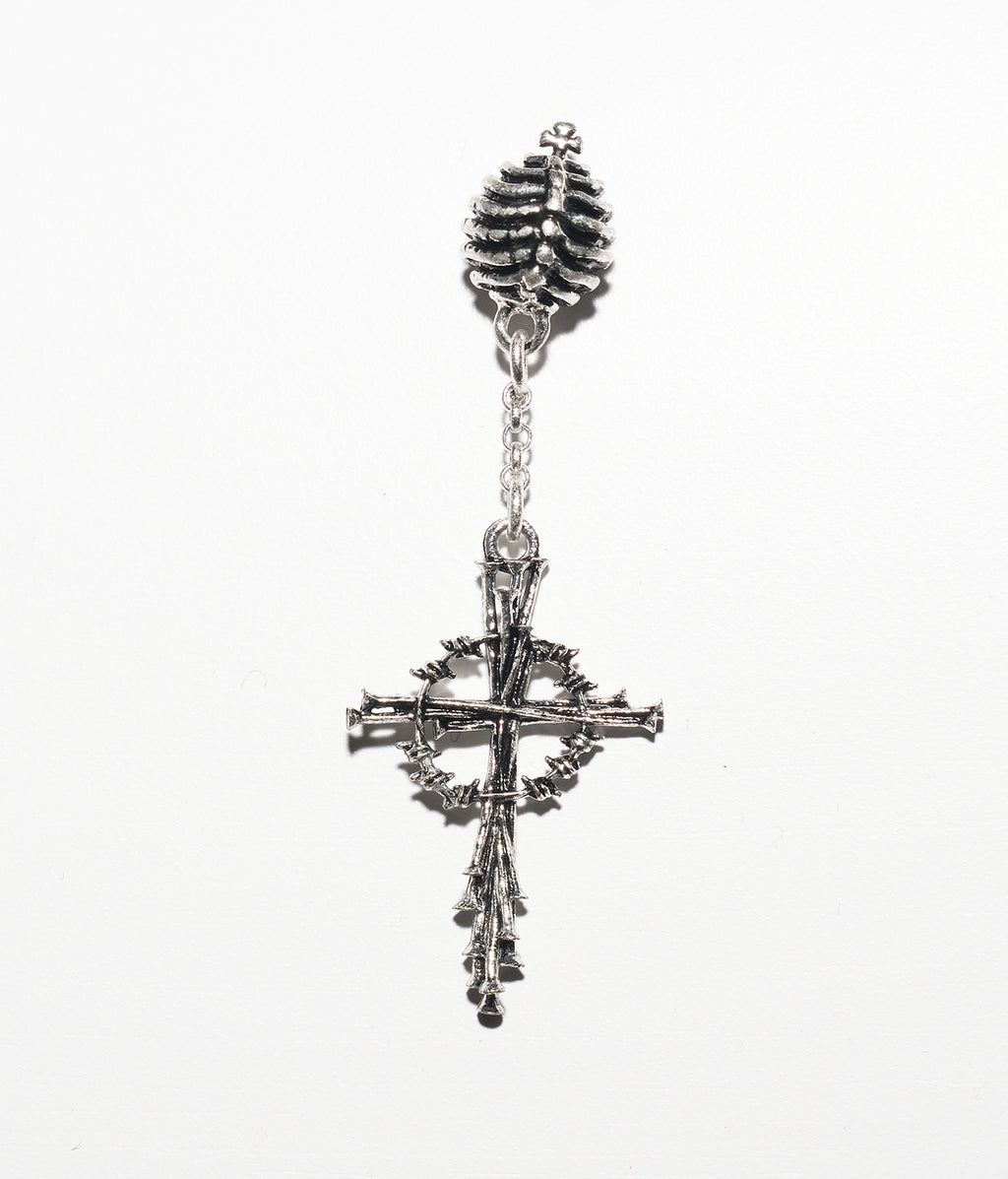 Silver cross earring with intricate design on a white background