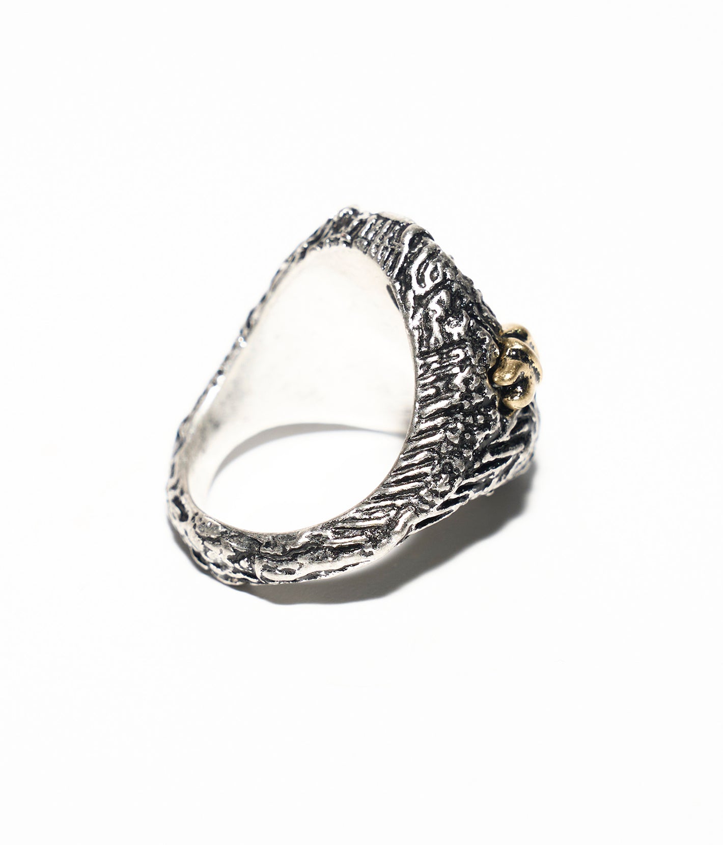 Silver ring with intricate design on a white background